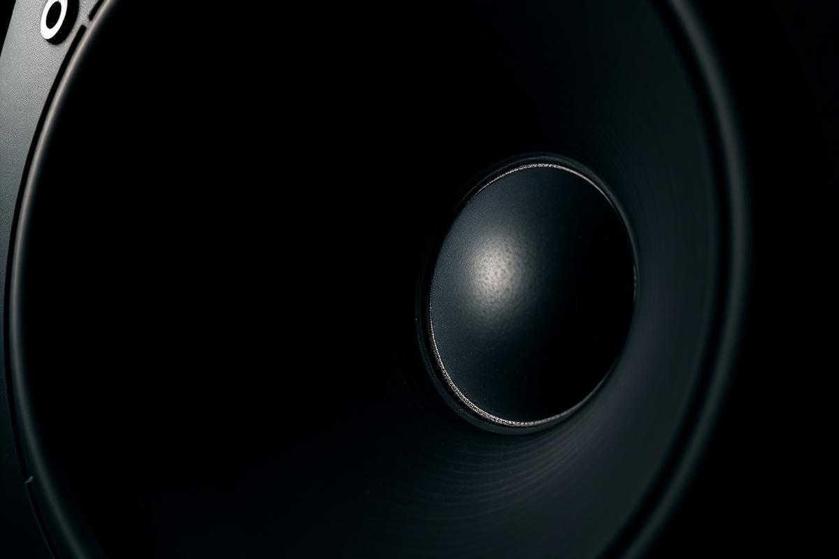 speaker cone vibrating showing the physical power of increasing decibel levels